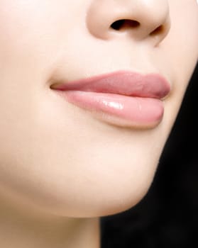 Young woman's glossy pink lips-copyspace