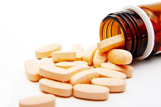 Pills from bottle on the white background