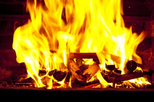 Fire wood burns in a fireplace