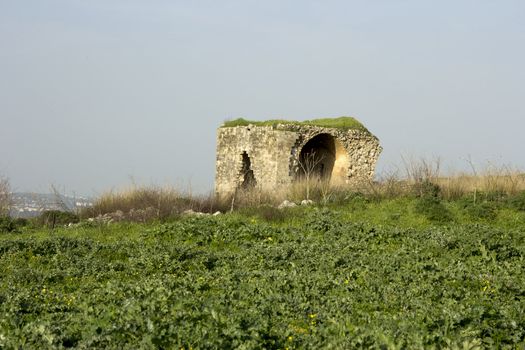 Old abandoned standing alone ruined house