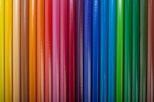 A vivid image with various colored pencils such as yellow, orange, red, pink, green and blue.