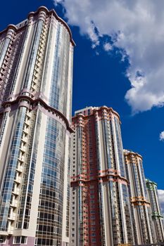 High modern apartment buildings under blue sky