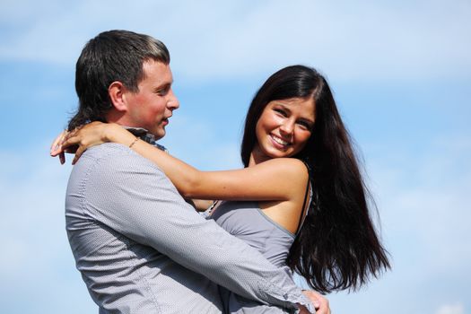 man and woman hug in the sky