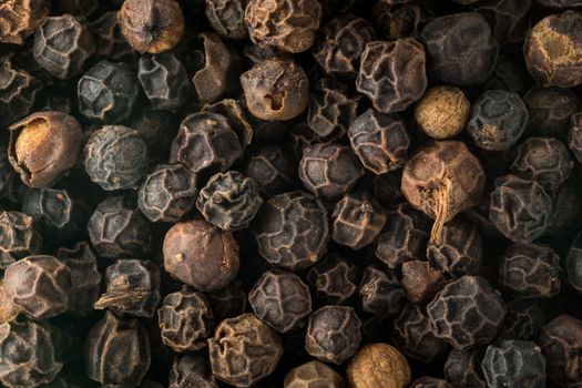 Black pepper corn seeds in macro photo