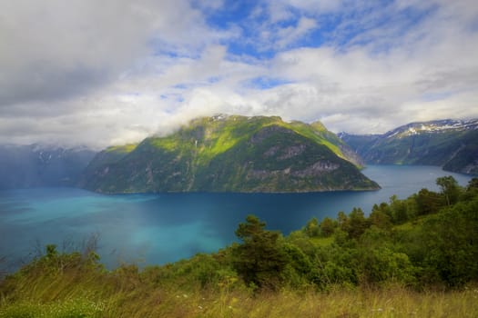 The Geiranger fjord in Norway, surrounded by high mountains