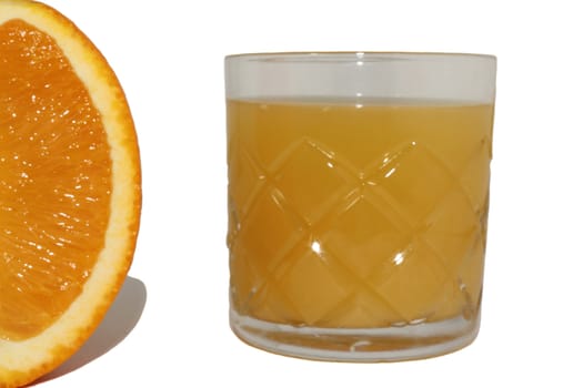 Orange juice in a glass and the orange cut half-and-half on a white background