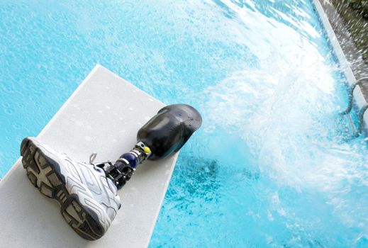 Cannonball splash in a pool with prosthetic leg left on diving board.