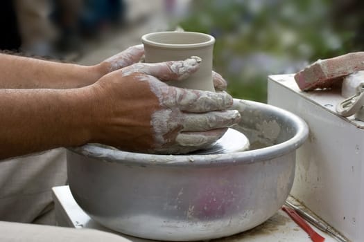 Masters hands making a pot