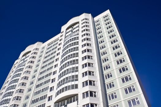 High modern apartment building under blue sky