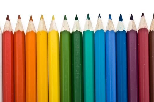 Coloured pencils with shadow on white background