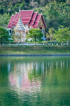 Fairy-tale buddhist temple with reflection in a lake