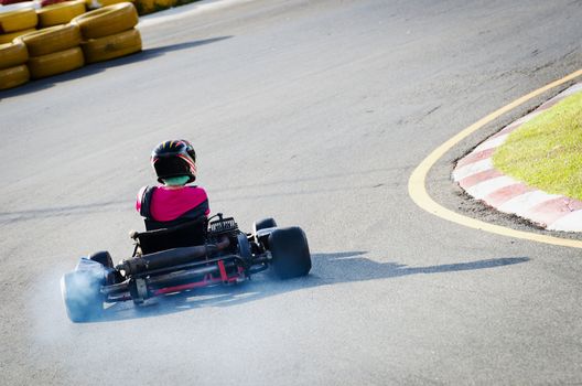 Karting - driver in helmet rushes on kart circuit