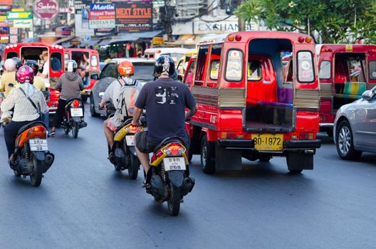 Patong, Phuket, Thailand - January 16, 2012: Intensive traffic on Patong street with taxi, motorbikes, cars in high tourist season