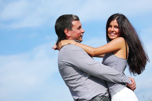 man and woman hug in the sky