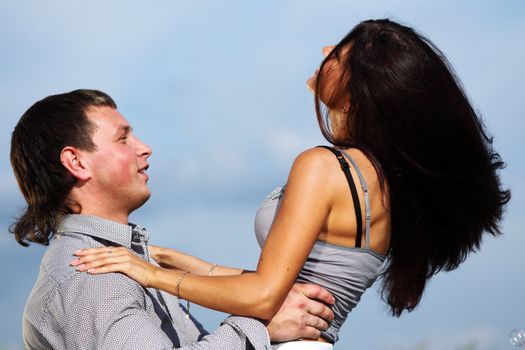man and woman hug in the sky