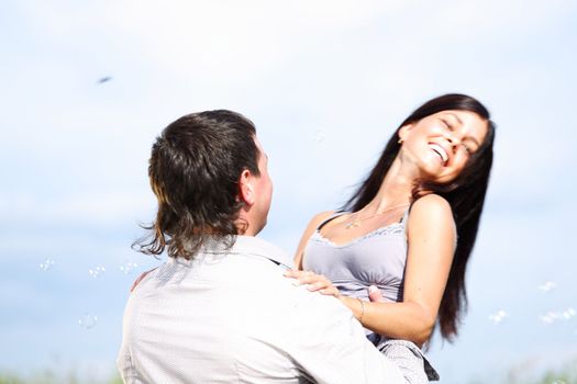 man and woman hug in the sky