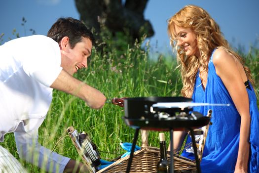 man and woman on picnic in green grass