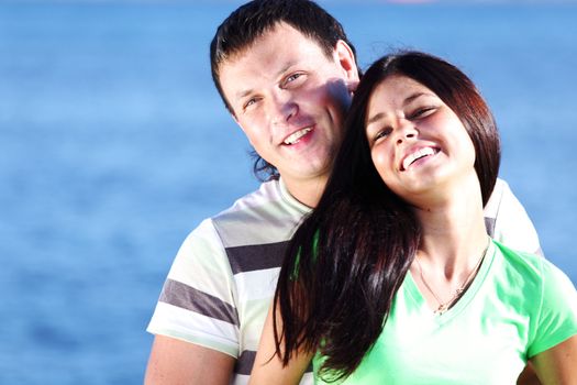 man and woman hug in the sky sea on background