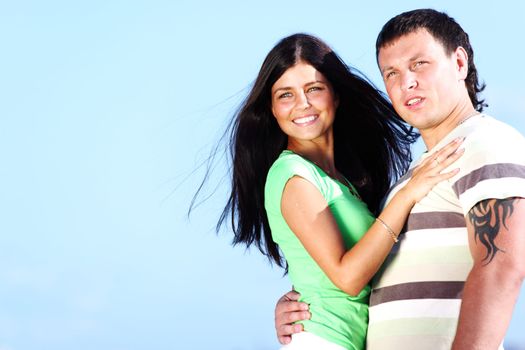 man and woman hug in the sky sea on background