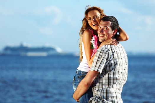 man and woman hug in the sky and sea on sea