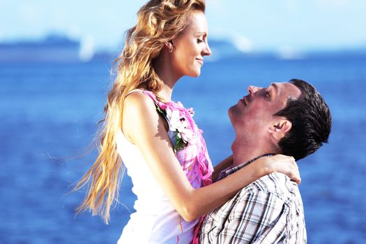 man and woman hug in the sky and sea on sea