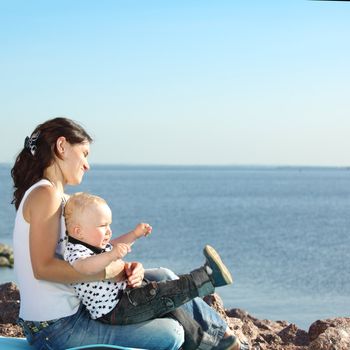 happy mother and son on picnic near sea