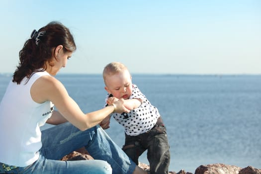 happy mother and son on picnic near sea
