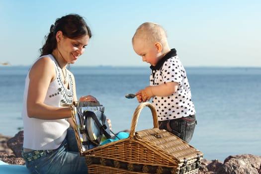 happy mother and son on picnic near sea