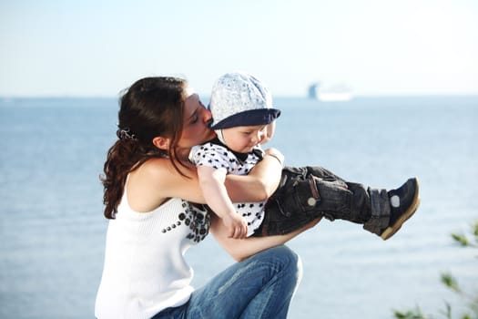 happy mother and son on picnic near sea