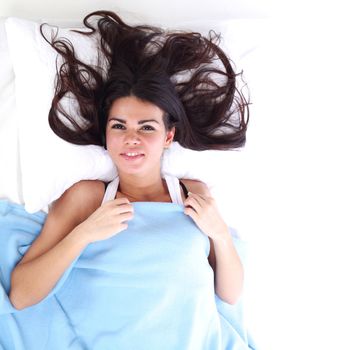 waking woman on the white pillow