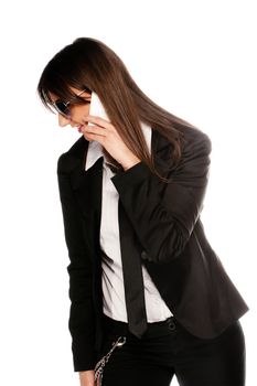 Sideshot of a business girl with glasses talking on a phone isolated on white