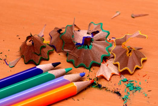 Pencils with a sharpener and shaving on a table