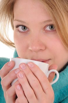 Nice blonde woman in sweater holds white cup with hot drink