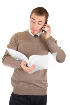 Man with mobile phone is looking in papers in a file in his hands. Isolated on white background.