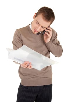 Confused man with mobile phone is looking in papers in a file with documents. Isolated on white background.