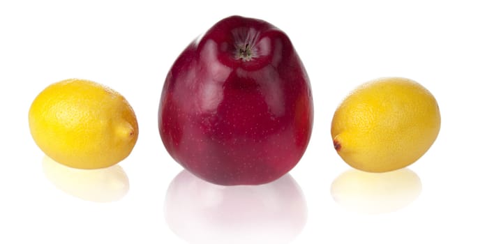 Apple and two lemons with soft reflections. Image include two clipping pathes for fruits with reflections and without them.