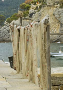 Closeup of a fishnet with boats on the back