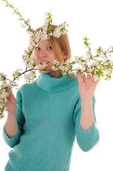 Smiling blonde woman with spring white cherry flowers. Focus on woman's eyes.