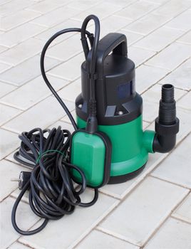 Pump for irrigation of plants is on  a concrete   floor