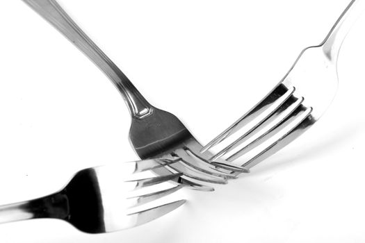 Shiny stainless steel forks on a white background