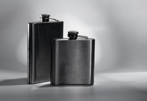 One of the most favorite men's toy - a metal flask for alcoholic beverages. Two used jars of stainless steel for whiskey or brandy