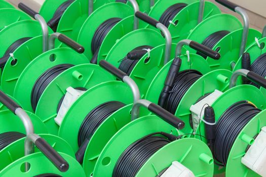 Group of green cable reels for new fiber optic installation