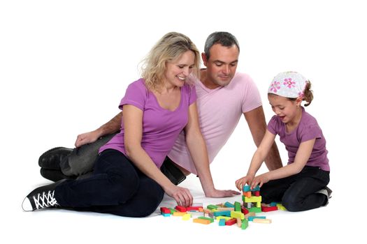 Parents and daughter playing building game