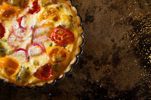 Delicious small tart with tomato, radish and cheese