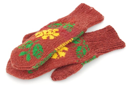 Two crocheted color mittens on a white background