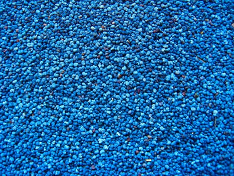 Dark blue background from grains of a poppy