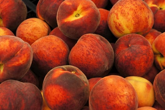 Heap of fresh  peaches on display at a market