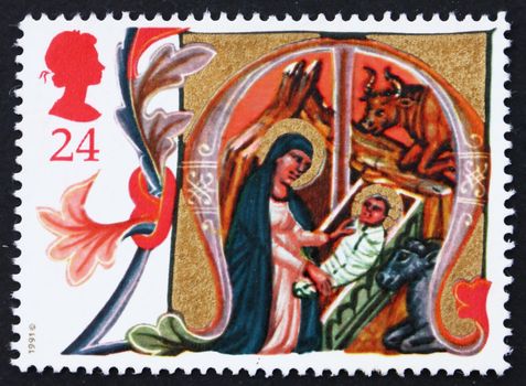 GREAT BRITAIN - CIRCA 1991: a stamp printed in the Great Britain shows Mary placing Jesus in Manger, Illuminated Letters from Venetian Manuscript, Christmas, circa 1991