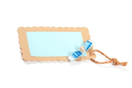 Blank tag tied with brown string. Price tag, gift tag, sale tag, address label, etc.