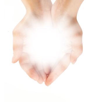 Female hands holding a brilliant shine in the dark